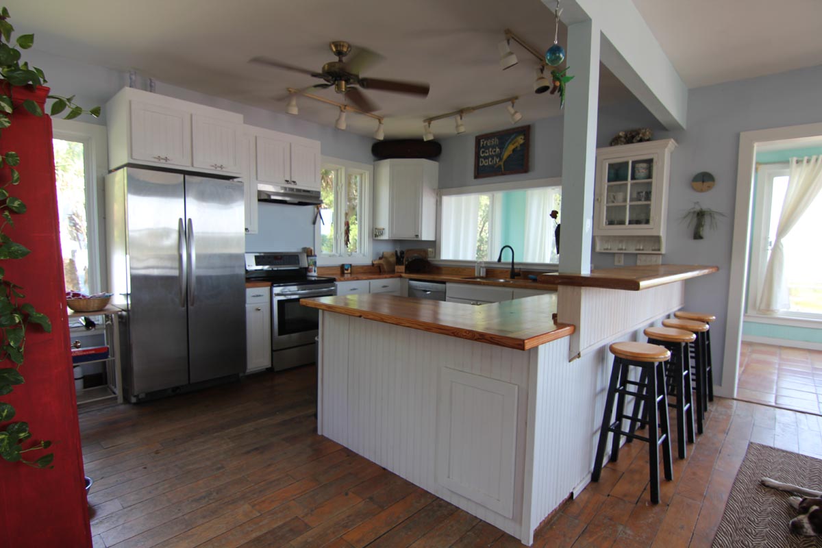 Open kitchen with raised bar seating at Goat Island Resort Rental House