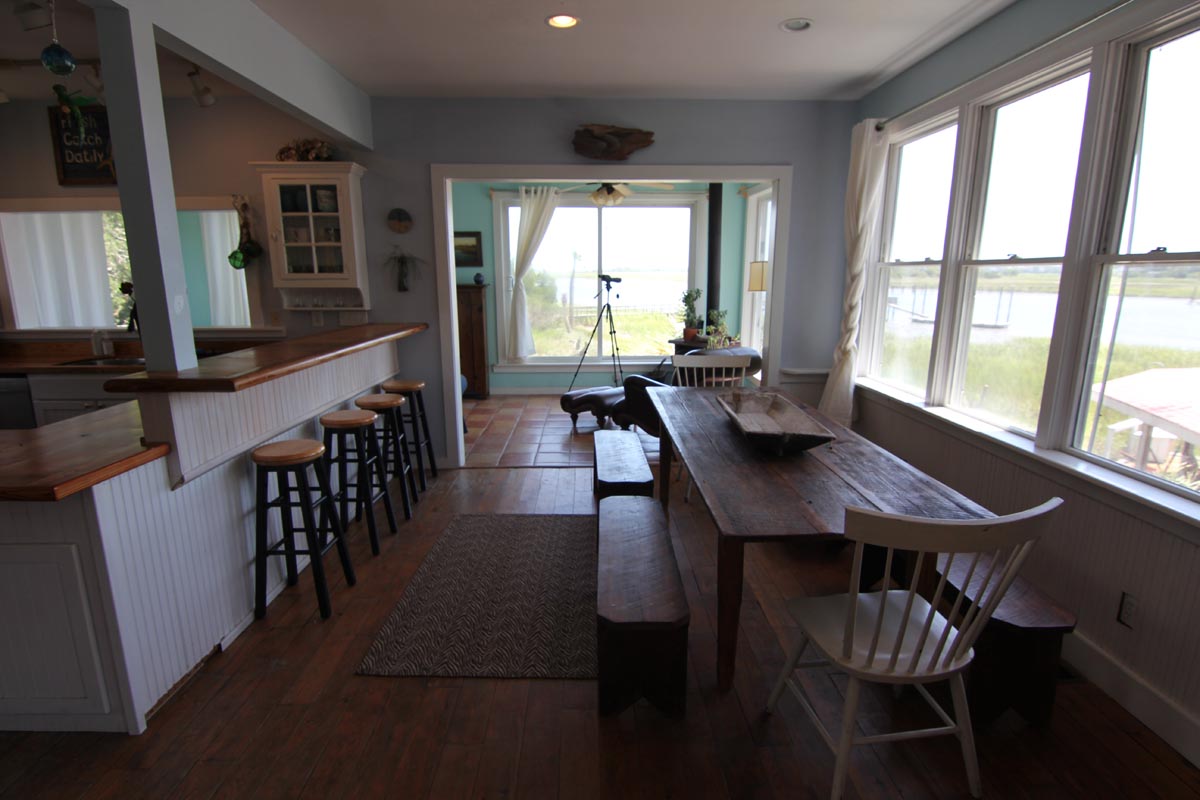 Farmhouse dining table with water views at Goat Island Resort Rental House