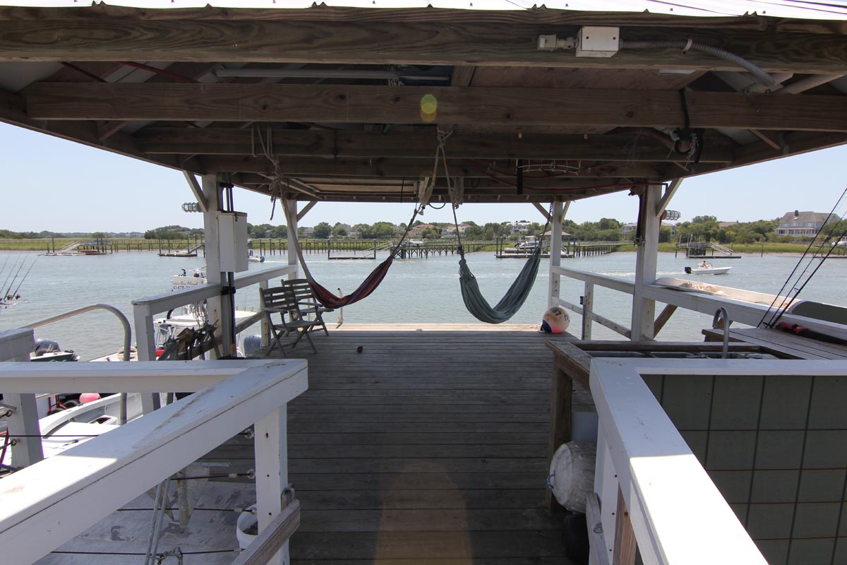 Covered dock at Goat Island Resort with hammocks, seating, and views over the Intracoastal Waterway