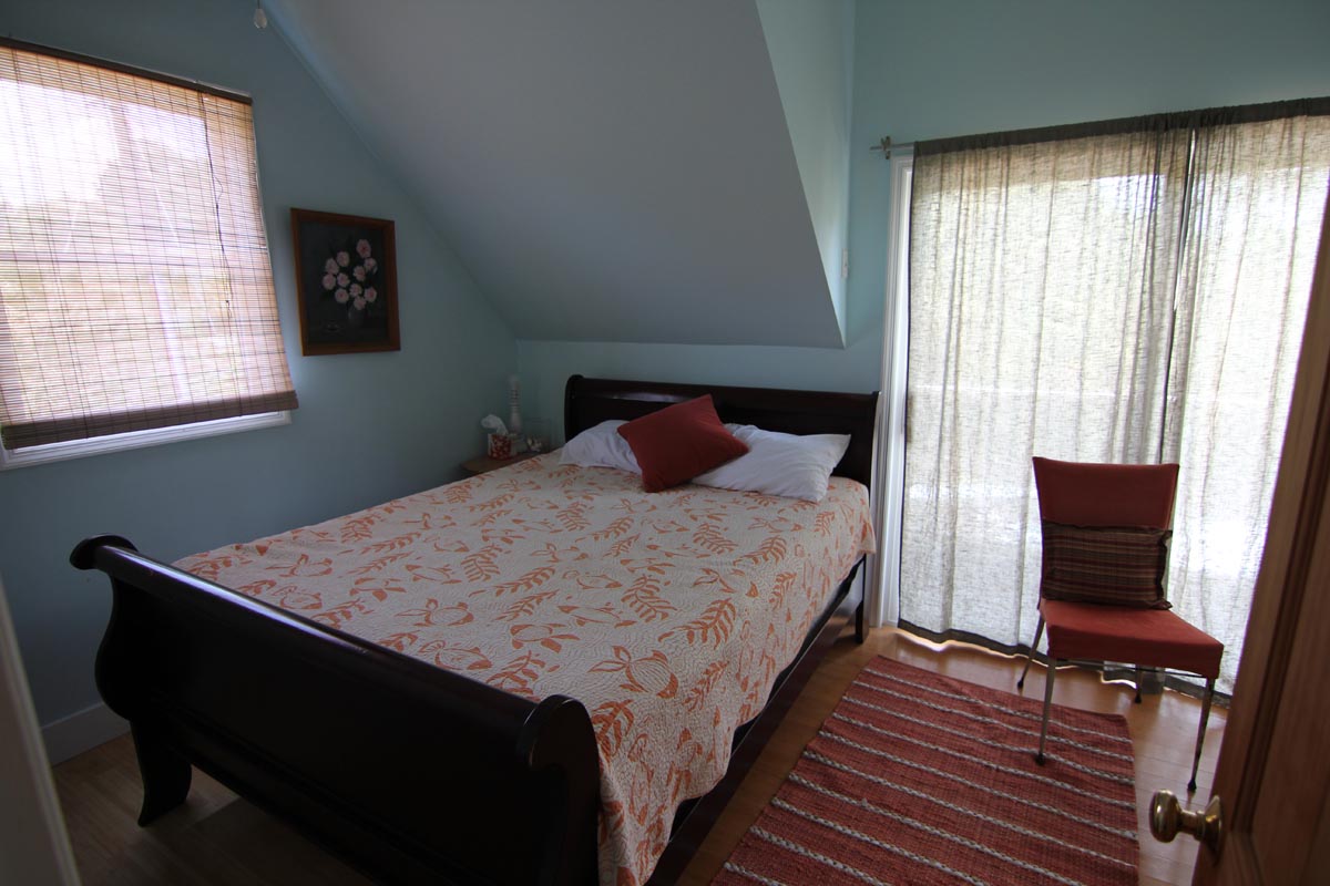 Cozy guest bedroom with water views at Goat Island Resort