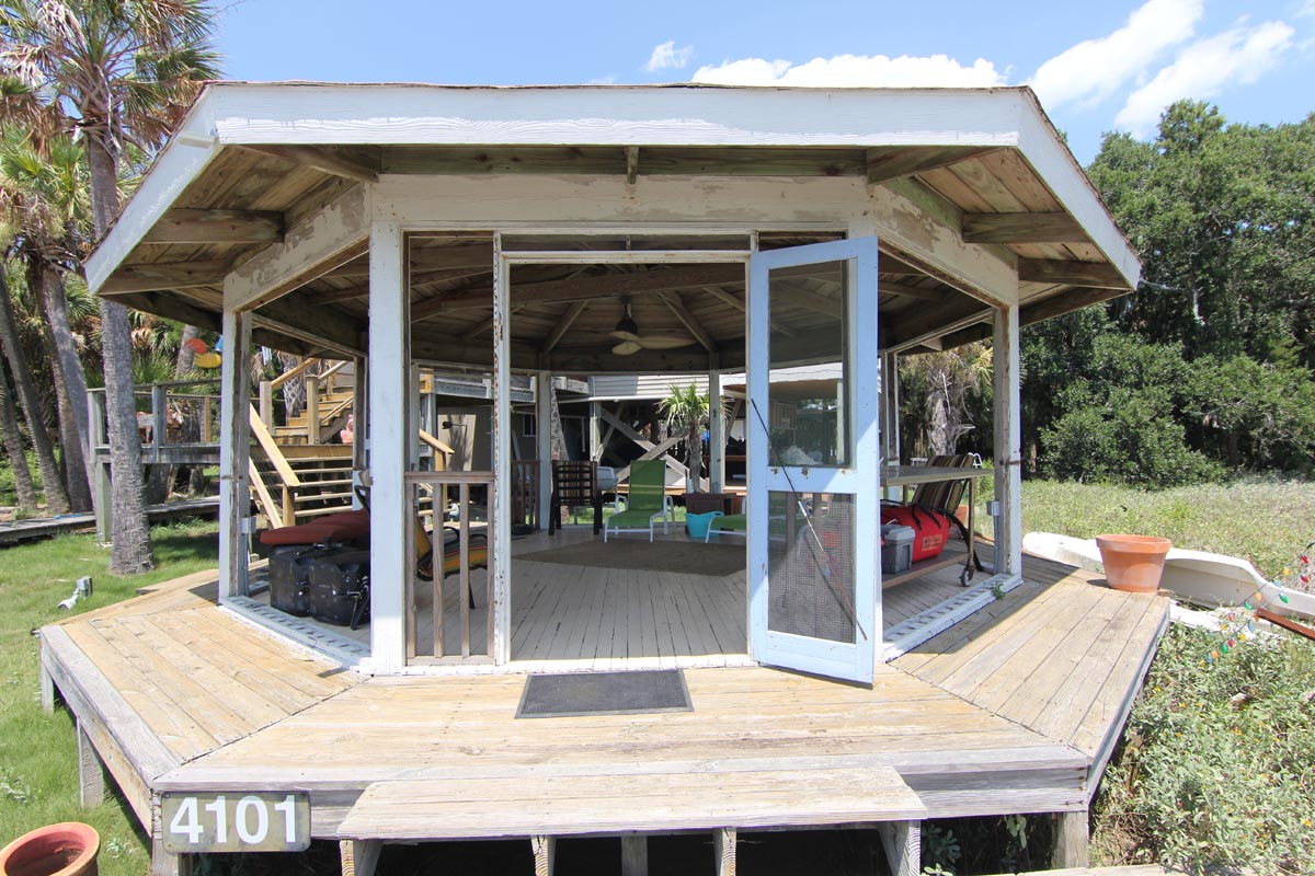 Waterfront gazebo on Goat Island under blue skies, surrounded by palmettos